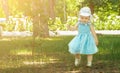 Baby`s first steps. cute caucasian one year old child girl walking in the park in summer Royalty Free Stock Photo