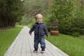 Baby`s first steps.The first independent steps. Running toddler in the park Royalty Free Stock Photo