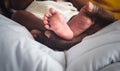 Baby`s foot of African black skin baby newborn, Placed on the father`s hand Royalty Free Stock Photo