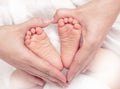 Baby`s foot in mother hands closeup Royalty Free Stock Photo