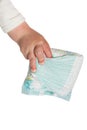 Baby's hand hold dirty diapers Royalty Free Stock Photo