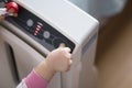 The baby`s hand pressing the power button on the air purifier to clean up the polluted air Royalty Free Stock Photo