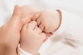 baby`s hands holding mother`s hand. The emotional bond between mother and child.