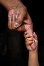 A baby`s hands holding tightly A senior man`s old age finger. Family, Generation, Support and people concept. Royalty Free Stock Photo