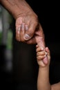 A baby`s hands holding tightly A senior man`s old age finger. Family, Generation, Support and people concept. Royalty Free Stock Photo