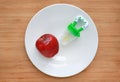 Baby`s nibbler and red apple on white plate against wooden background. Organic baby food concept Royalty Free Stock Photo