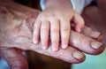 Baby`s And Old Rough Grandma`s Hand