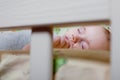 Baby`s restful sleep. Newborn baby in a wooden crib. The baby sleeps in the bedside cradle. Safe living together in a bedside cot Royalty Free Stock Photo