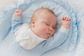 Baby`s restful sleep. Newborn baby in a wooden crib. The baby sleeps in the bedside cradle. Royalty Free Stock Photo