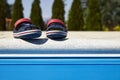Baby sandals at the edge of swimming pool