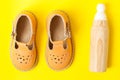 Baby sandals and wooden eco toy, baby`s first shoes Royalty Free Stock Photo