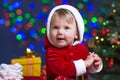 Baby Santa Claus near Christmas tree with gifts Royalty Free Stock Photo