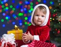 Baby Santa Claus near Christmas tree with gifts Royalty Free Stock Photo