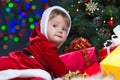 Baby Santa Claus near Christmas tree with gifts Royalty Free Stock Photo