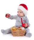 Baby in Santa hat playing with Christmas balls Royalty Free Stock Photo