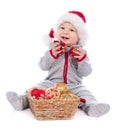 Baby in Santa hat playing with Christmas balls Royalty Free Stock Photo