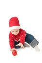 Baby in Santa hat playing with Christmas balls, isolated on white Royalty Free Stock Photo