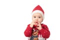 Baby in Santa hat playing with Christmas balls, isolated on white Royalty Free Stock Photo