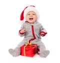 Baby in Santa hat playing with Christmas gift box Royalty Free Stock Photo