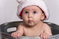 Baby with Santa Hat sitting in Wash Basin Royalty Free Stock Photo