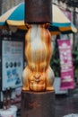 Baby Sculpture in The Middle of Rusted Black Iron Pole from The Street of George Town. Penang, Malaysia Royalty Free Stock Photo