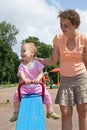 Baby on seesaw with mother Royalty Free Stock Photo