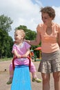 Baby on seesaw with mother