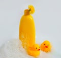 Baby shampoo with herbs on a white background, rubber yellow ducks Royalty Free Stock Photo