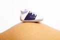 Baby shoe on belly, pregnant