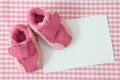 Baby shoes and blank note Royalty Free Stock Photo