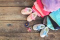 Baby shoes, clothing and pacifiers pink and blue on the old wooden background. Royalty Free Stock Photo