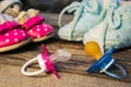 Baby shoes and pacifiers pink and blue on the old wooden background.