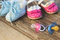 Baby shoes and pacifiers pink and blue Royalty Free Stock Photo
