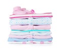 Baby shoes, pile of clothes and dummy Royalty Free Stock Photo