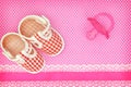 Baby shoes and pink pacifier Royalty Free Stock Photo