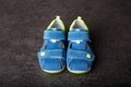 Baby shoes, small blue sandals on concrete background Royalty Free Stock Photo