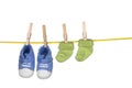 Baby shoes and socka hanging on a clothesline Royalty Free Stock Photo