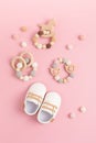 Baby shoes and teethers on pink background. Organic newborn fashion, branding, small business idea Royalty Free Stock Photo