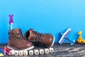 Baby shoes and toys on wooden floor near blue wall. Childhood concept. Copy space for text. The inscription CHILDHOOD from cubes Royalty Free Stock Photo