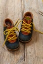 Baby shoes on wood, closeup view, child booties blue and yellow color Royalty Free Stock Photo