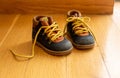 Baby shoes on wood, closeup view, child booties blue and yellow color Royalty Free Stock Photo