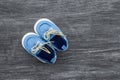 Baby shoes on a wooden background with space for text. Top view Royalty Free Stock Photo