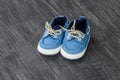 Baby shoes on a wooden background with space for text. Top view Royalty Free Stock Photo