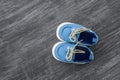 Baby shoes on a wooden background with space for text. Top view Royalty Free Stock Photo