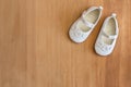 Baby shoes on wooden background - toddler white cute shoes on wood with space for text - top view photo Royalty Free Stock Photo