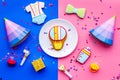 Baby shower. Cookies in shape of accesssories for child, party hats and confetti on pink and blue background top view Royalty Free Stock Photo