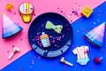 Baby shower. Cookies in shape of accesssories for child, party hats and confetti on pink and blue background top view Royalty Free Stock Photo