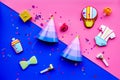 Baby shower. Cookies in shape of accesssories for child, party hats and confetti on pink and blue background top view Royalty Free Stock Photo