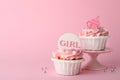 Baby shower cupcakes with toppers on pink background, space for text Royalty Free Stock Photo