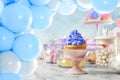 Baby shower party for boy. Treats on table in room decorated with balloons Royalty Free Stock Photo